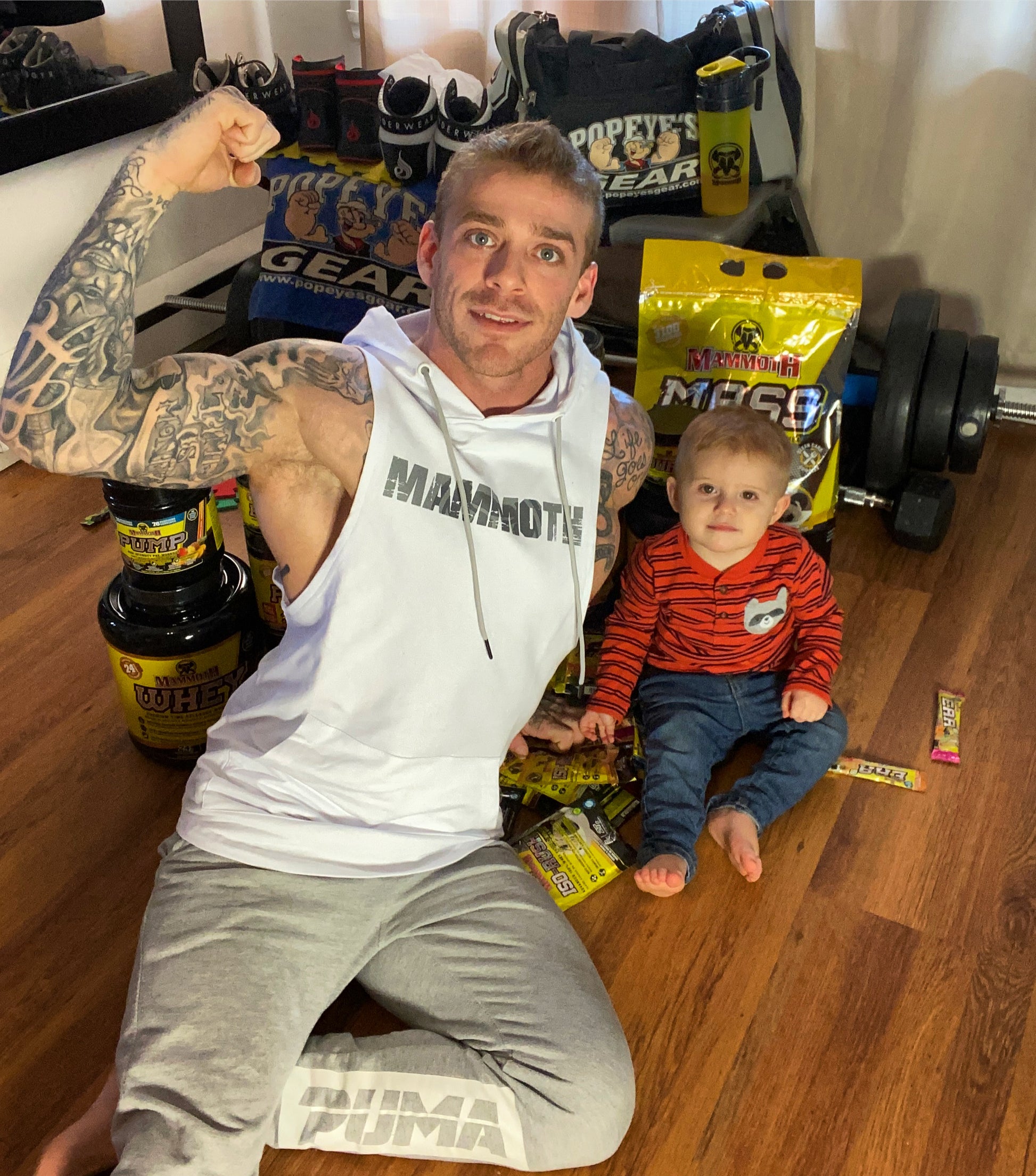 MAMMOTH White drop Sleeveless Hoodie. Show off your hard work at the gym or home workout. Weight training apparel. Bodybuilding. Men's Fitness Apparel. Canada. Men's training tank.  Edit alt text